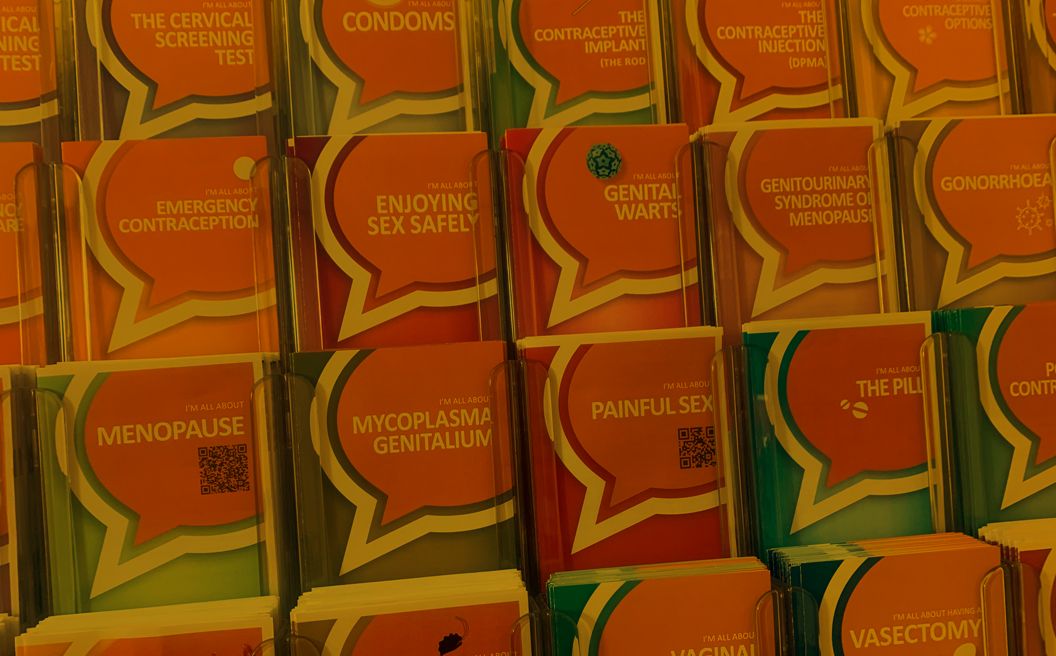 A photo of Sexual Health Information Brochures in a stand.