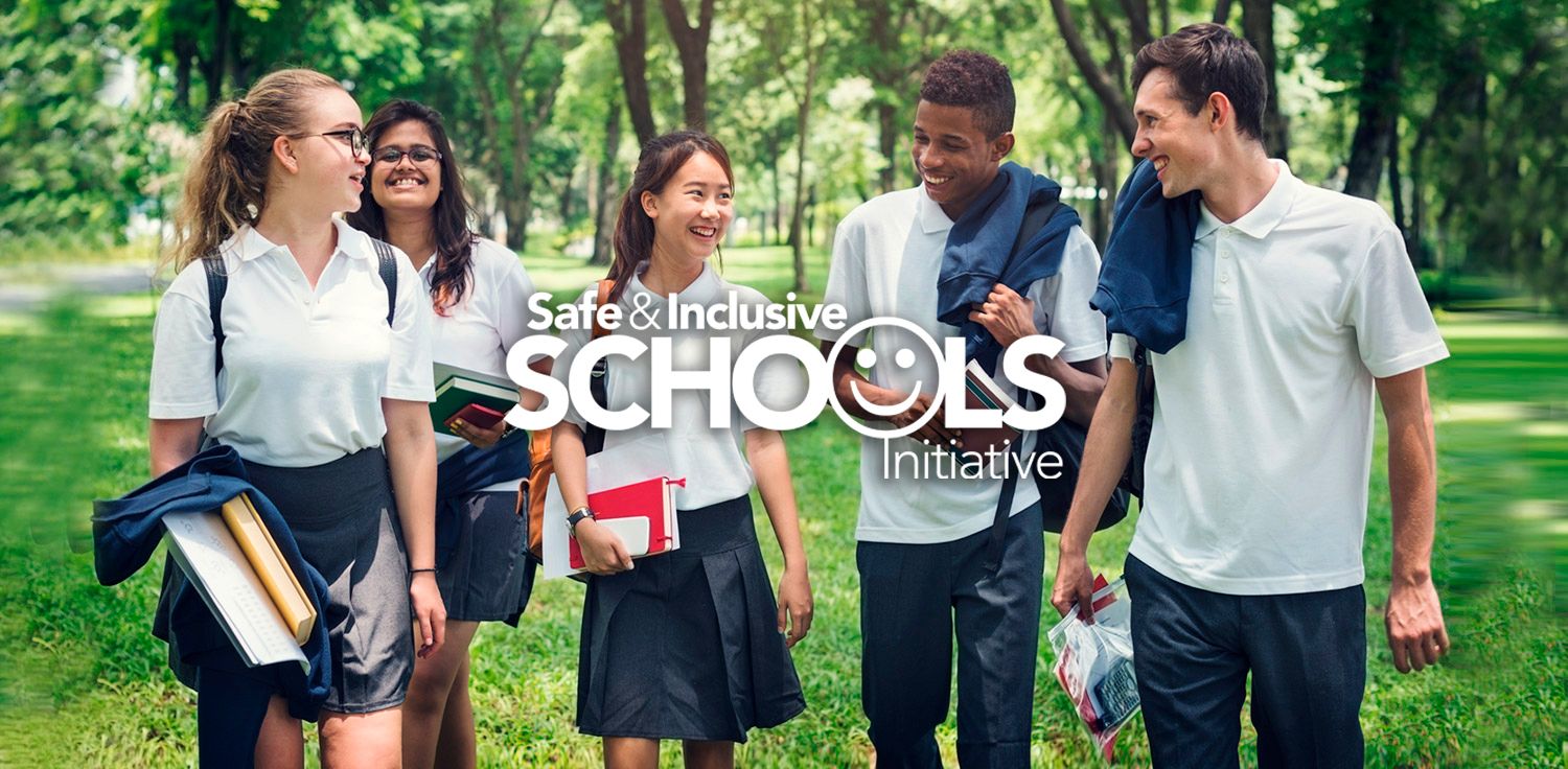 Five happy teenage students waling in the park