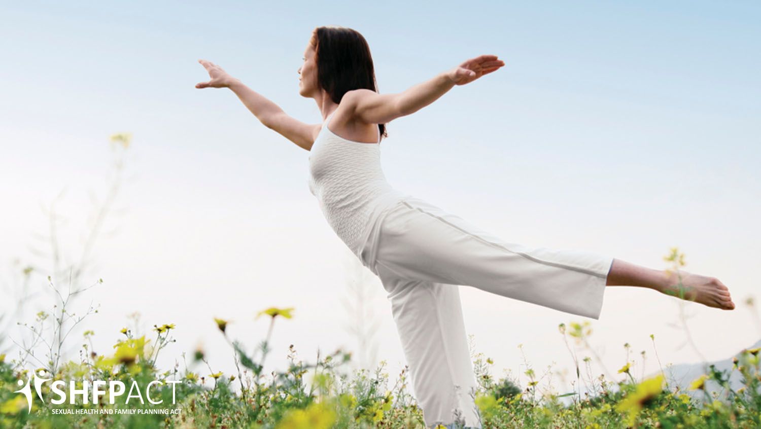 Woman dressed in white doing yoga in the park